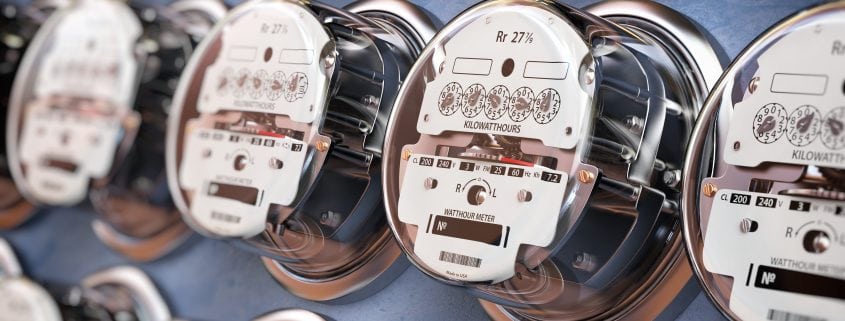 Electric meters in a row measuring power use. Electricity consumption concept.