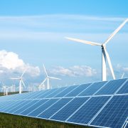 solar panel in green lawn with wind power station