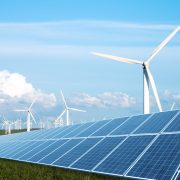 solar panel in green lawn with wind power station